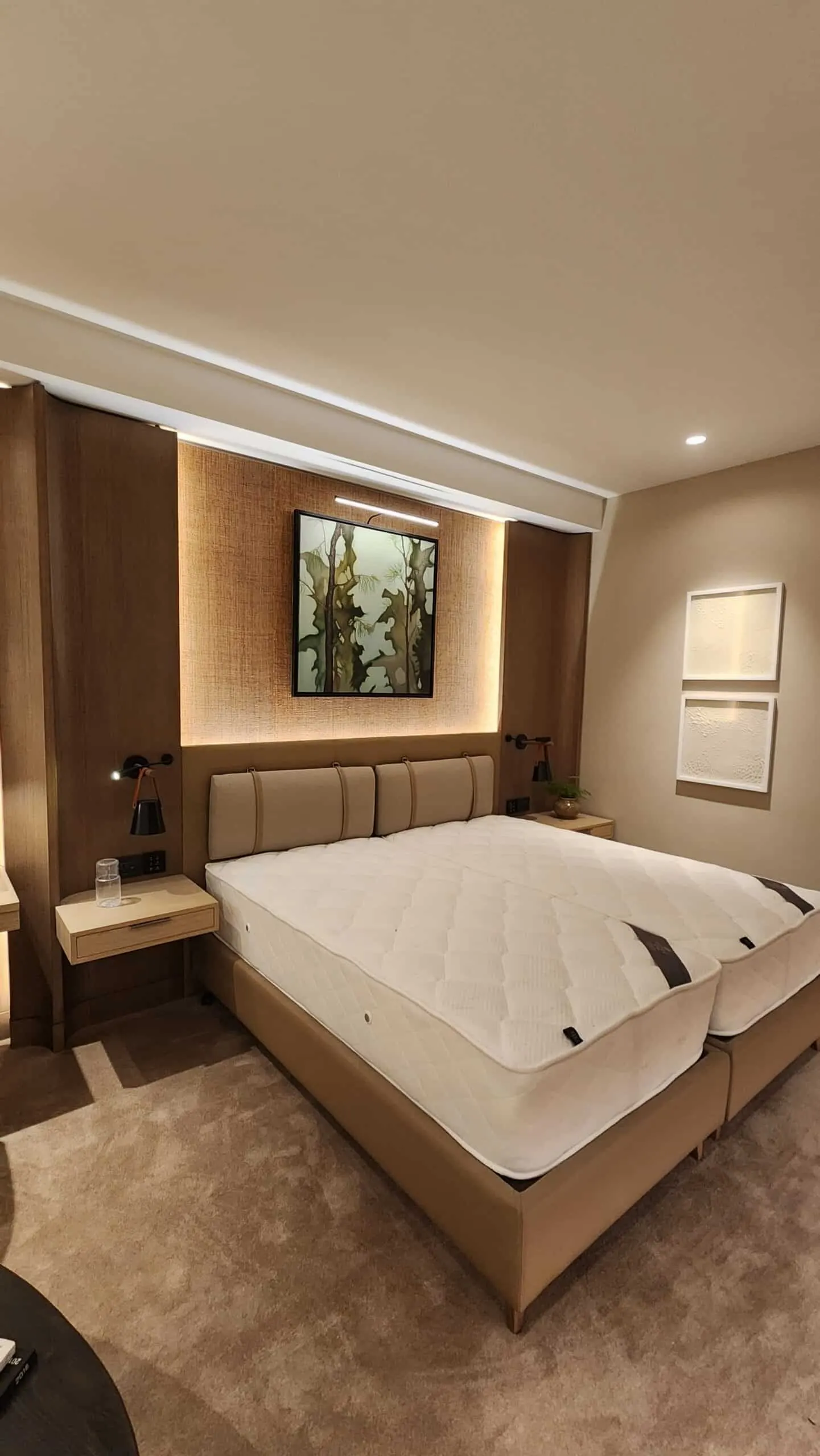 Prototype hotel guest room with upholstered headboard and timber wall panelling